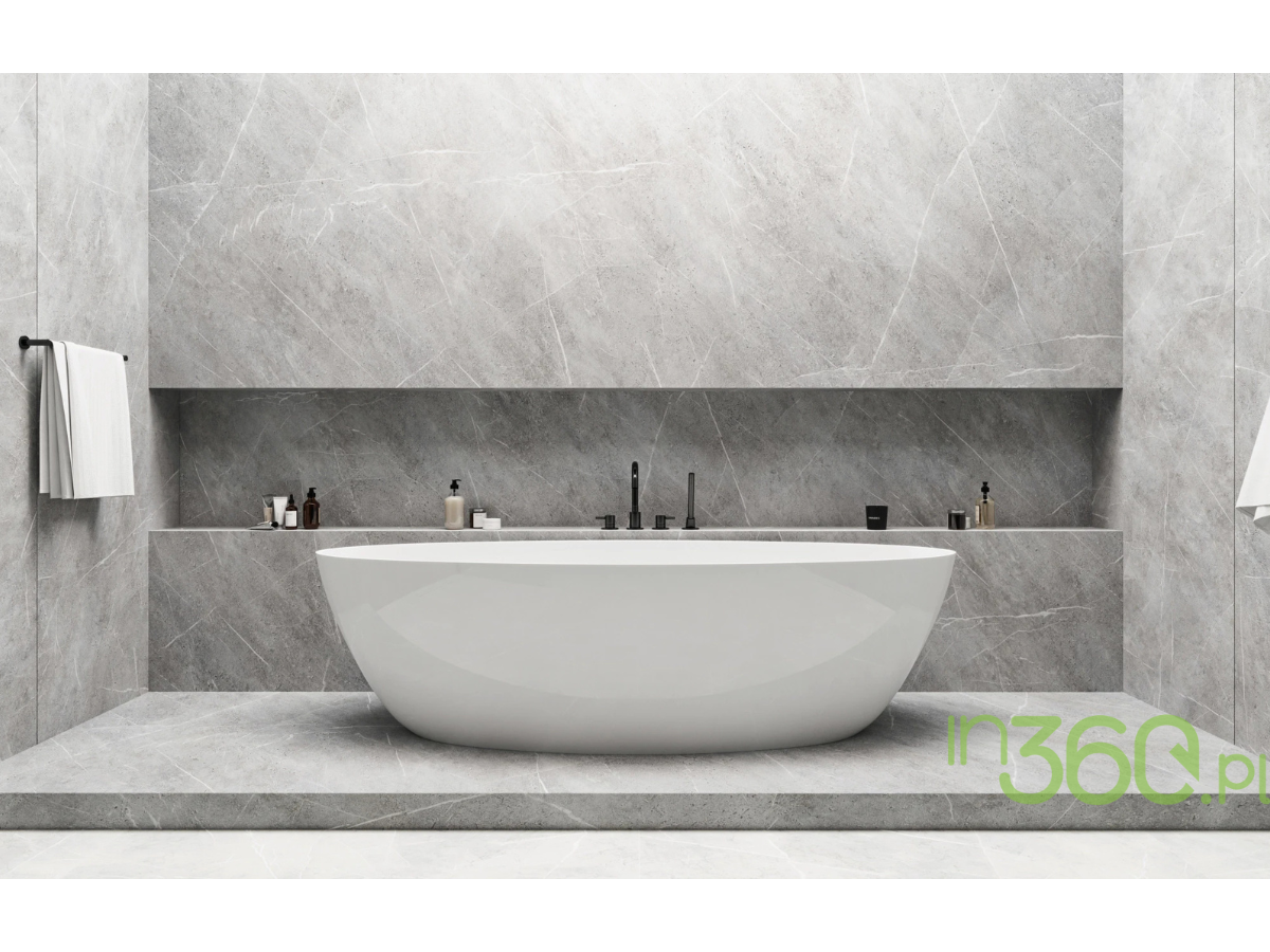 Wolnostojąca wanna Omnires Siena w białym połysku otoczona płytkami gresowymi Cifre